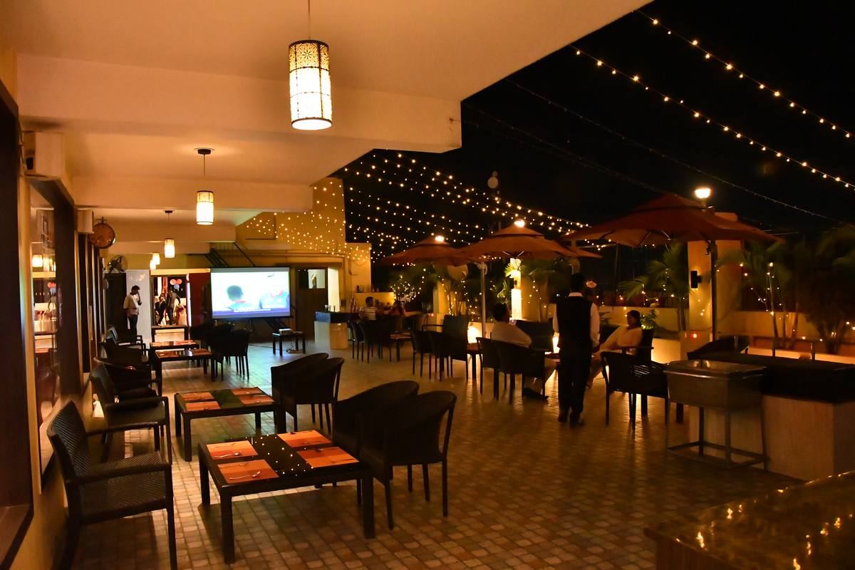 Chinmaye Inn rooftop at night, under string lights